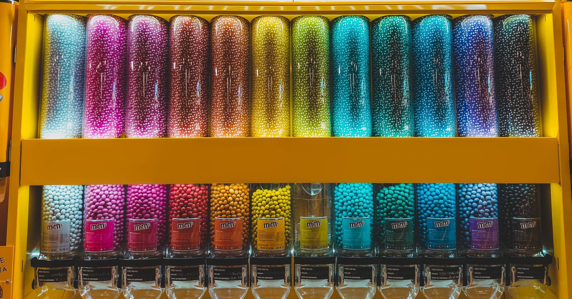 Rainbow tubes of a bulk candy dispenser in every color